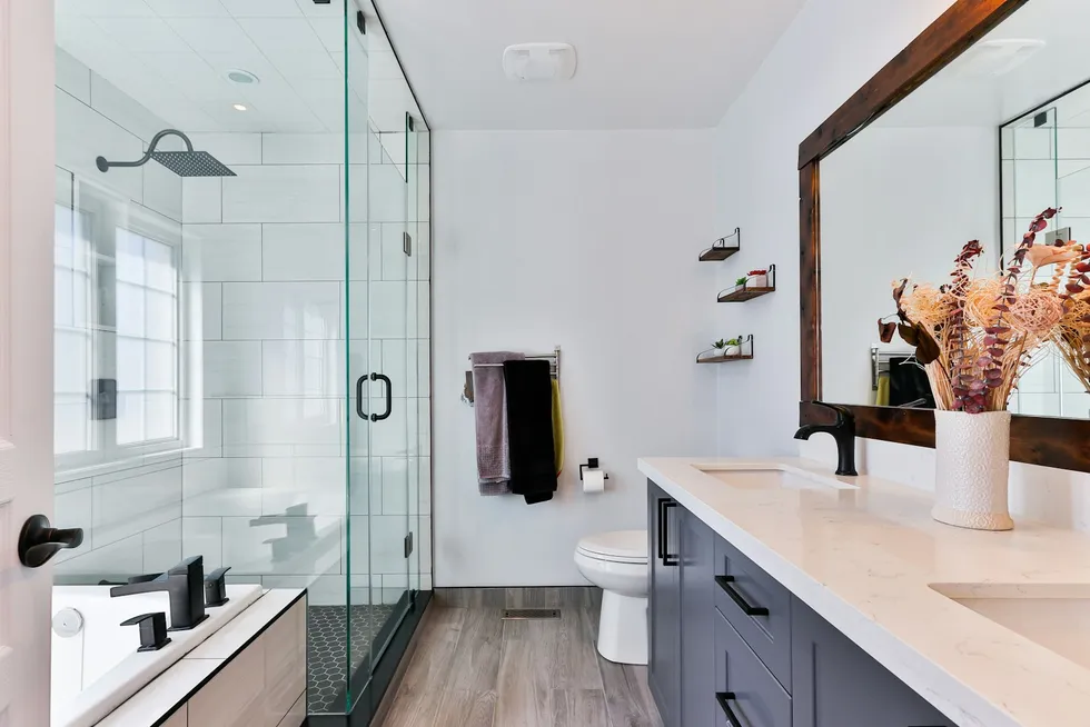 Walk-in tiled shower with a glass door